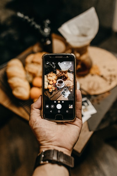 On a smartphone to capture bread and coffee
